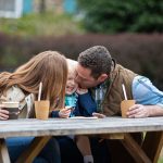 family eating bent spoon outside