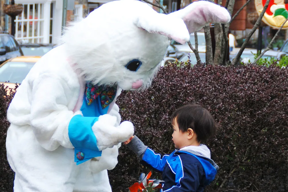 bunny rabbit costumed adult with child
