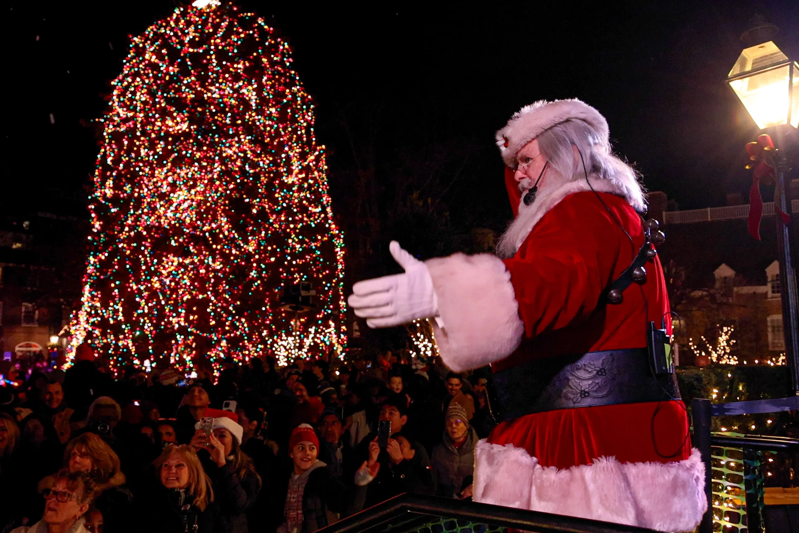 Santa greeting patrons, lit up Christmas tree