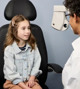 child receiving eye exam at warby parker