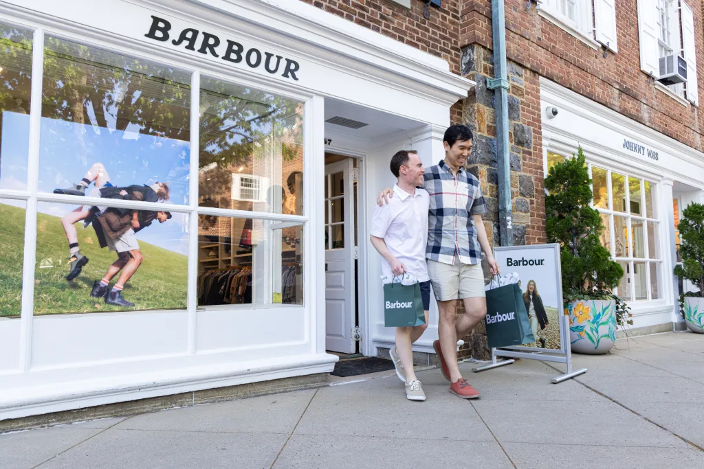 couple walking out of store after shopping
