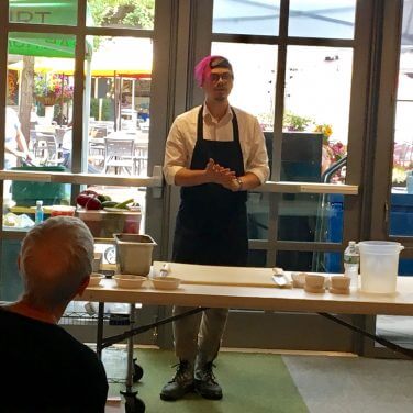 chef standing at table demonstrating cooking