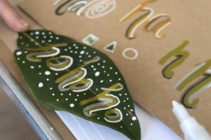 painting letters on a leaf