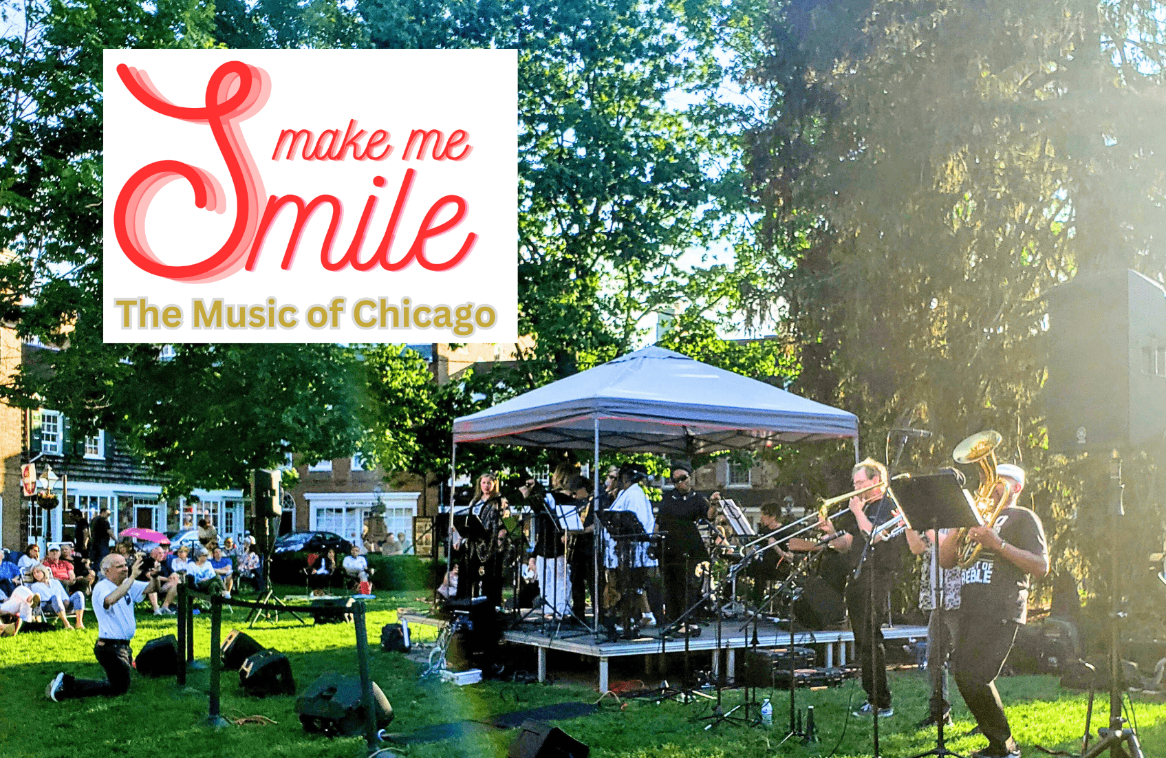 Make Me Smile, The Music of Chicago. Musicians playing instruments on a stage on a sunny day