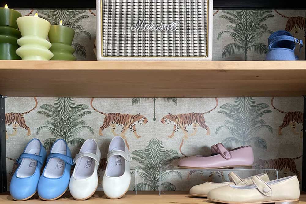 childrens shoes displayed on wooden shelf