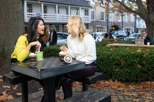 Two women eating ice cream outdoors