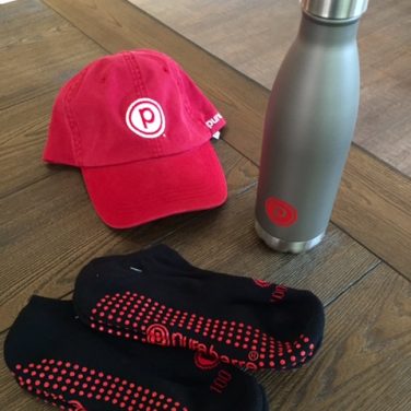 pure barre merch, hat, water bottle and sticky socks