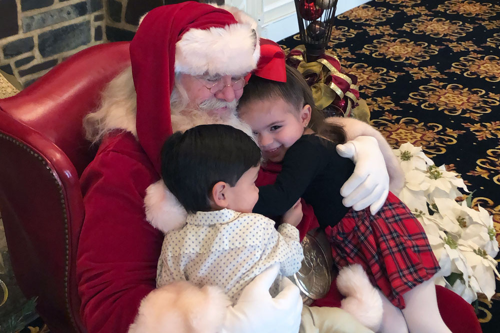 santa hugging kids