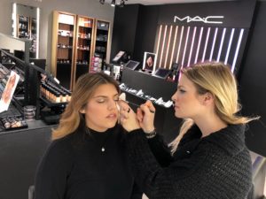 makeup artist with client at MAC cosmetics