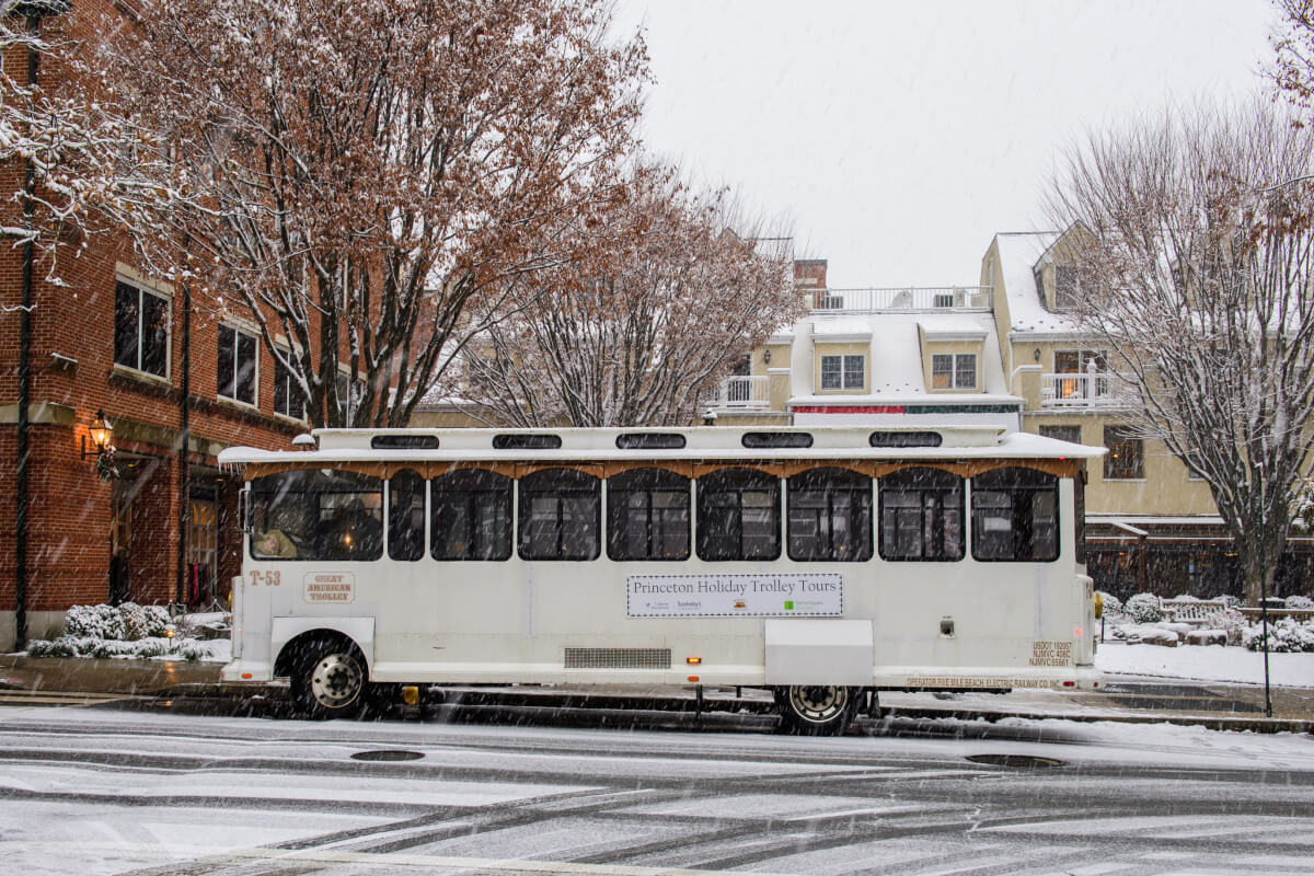 trolly going by, dusting of snow on streets